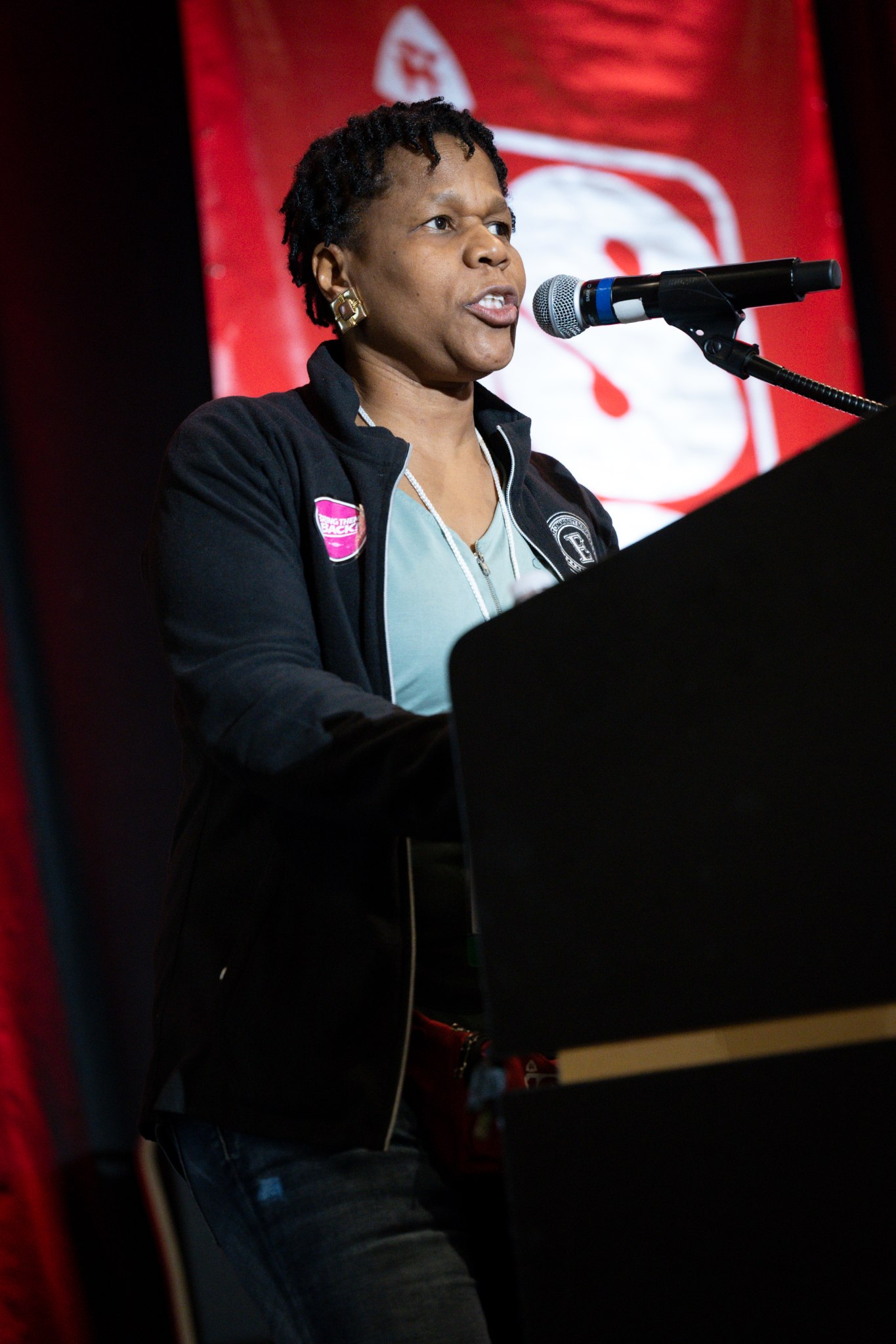 An educator speaking into a microphone